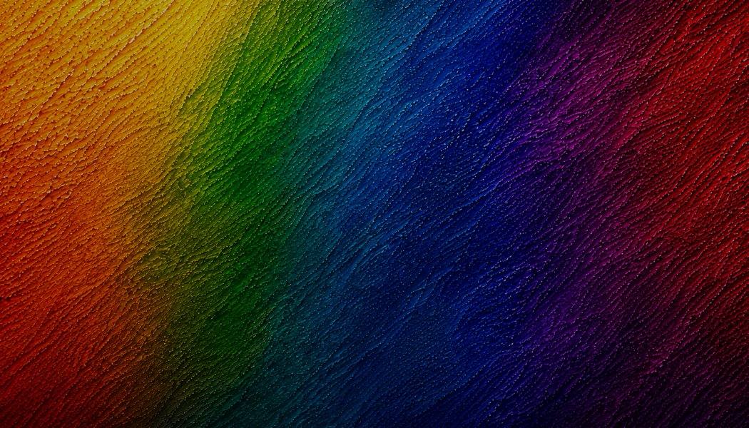 Rainbow gradient with diagonal diagonal texture lines transitioning from red to blue